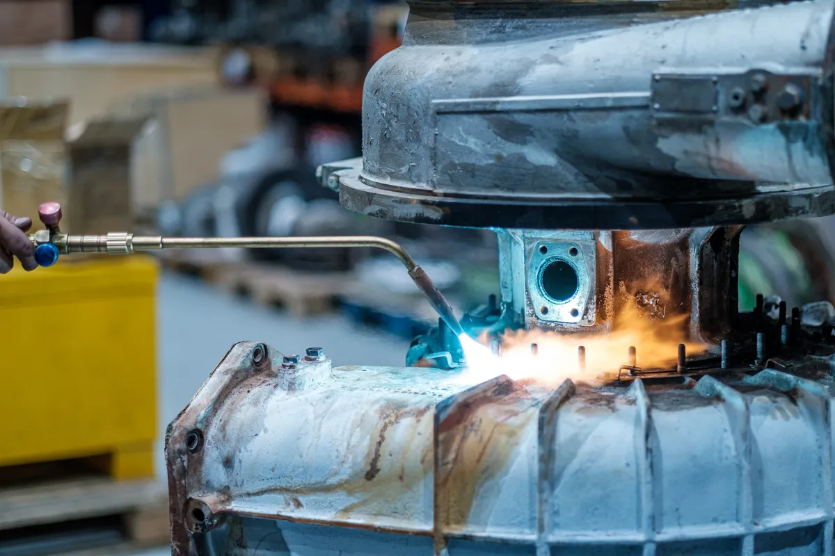 Controlled heating with a torch on the casing of a MAN NR29/S turbocharger during dismantling