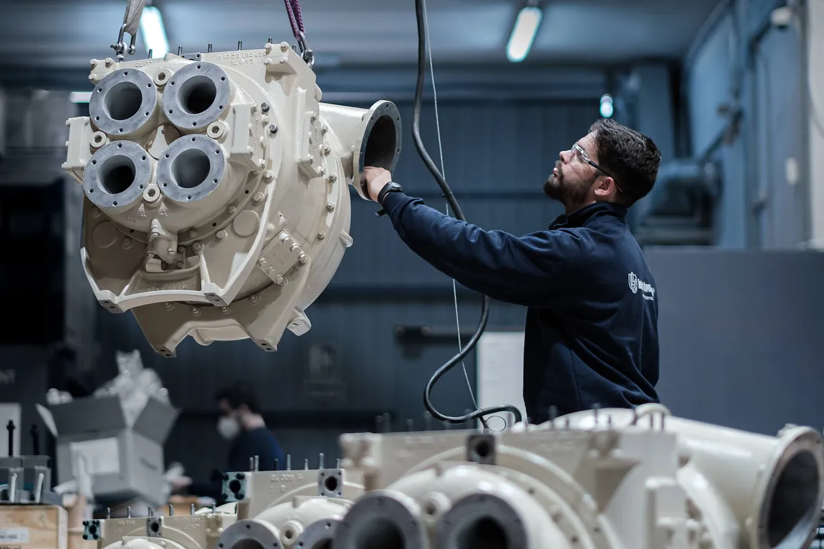 MTU AGL 340 turbocharger casing lifted by crane during overhaul