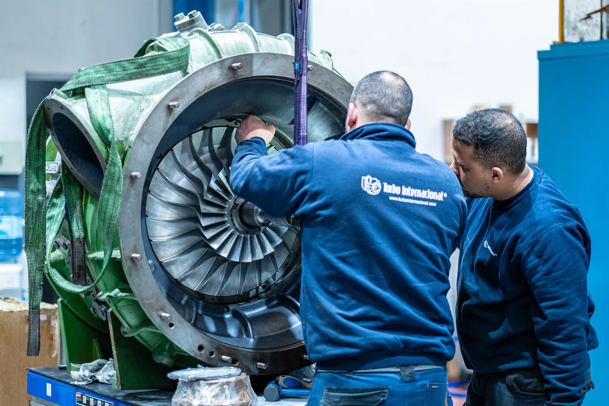 Turbo Internacional technicians working on the open end of a Napier NA455 turbocharger