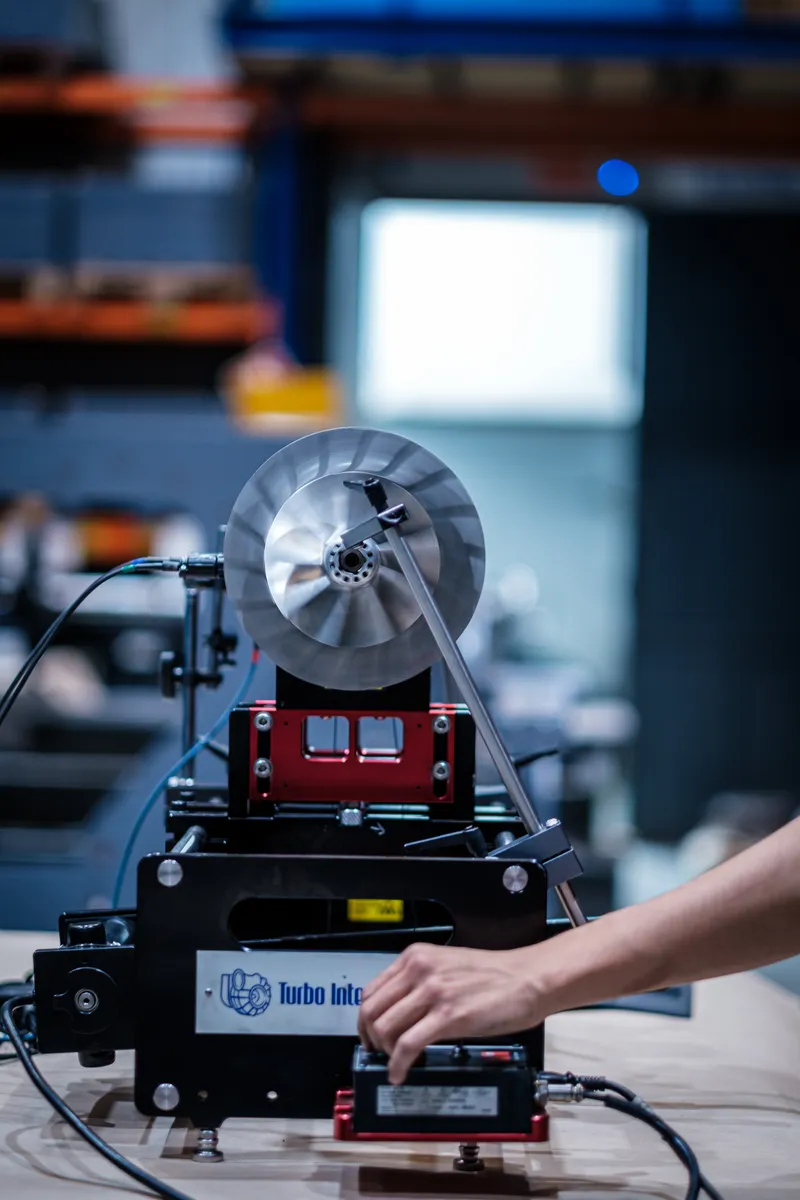 Portable balancing machine set up next to a turbocharger rotor on site
