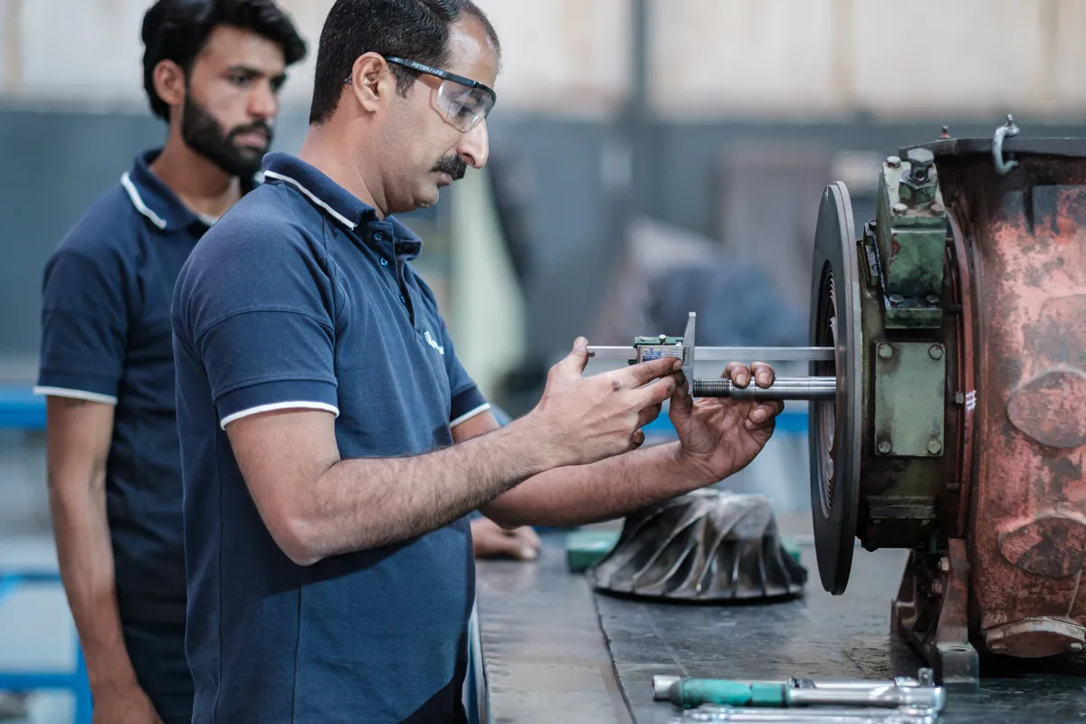 Technician measuring a turbocharger rotor with a calliper at Lahore