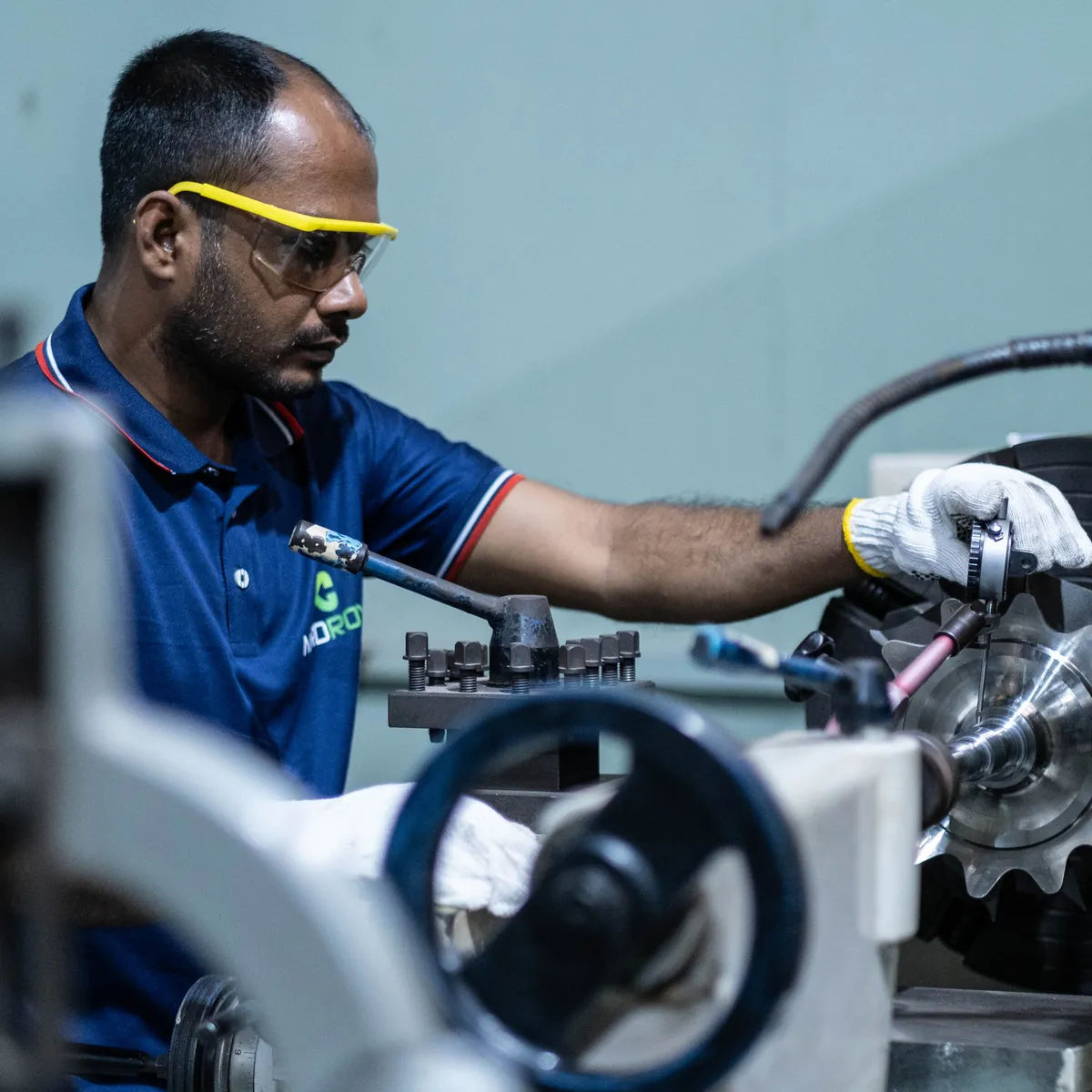 Technician machining a turbocharger component at the Dhaka workshop