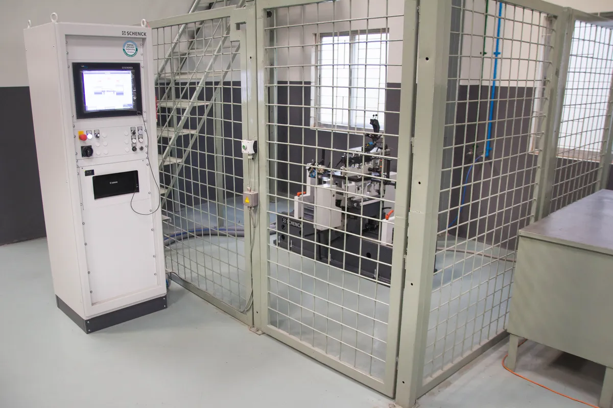 Balancing machine inside its safety enclosure at the Dhaka workshop