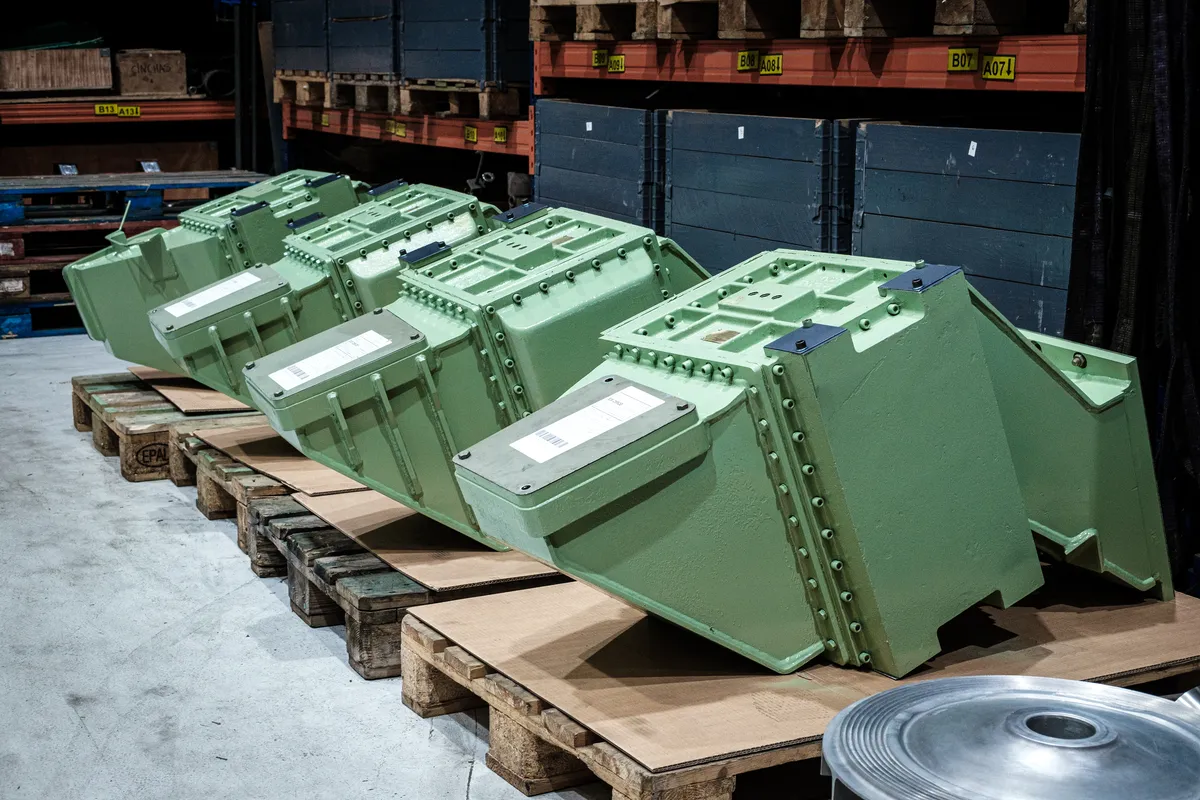 Row of overhauled charge air coolers on pallets, repainted and ready