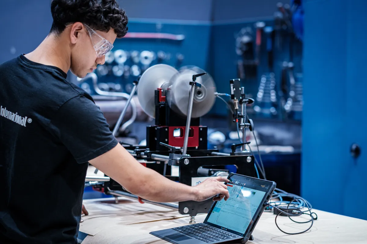 Technician running the balancing software next to a rotor on the portable machine