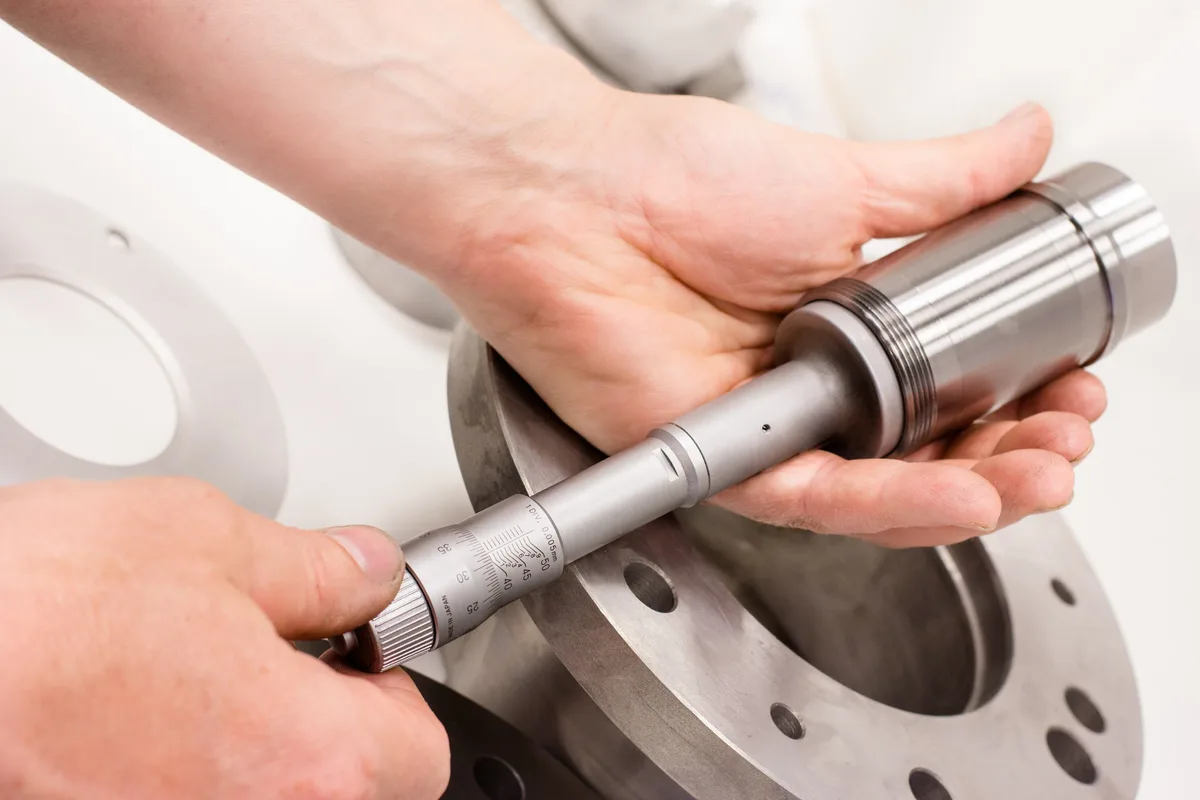 Bore of a bearing sleeve being measured with an internal micrometer