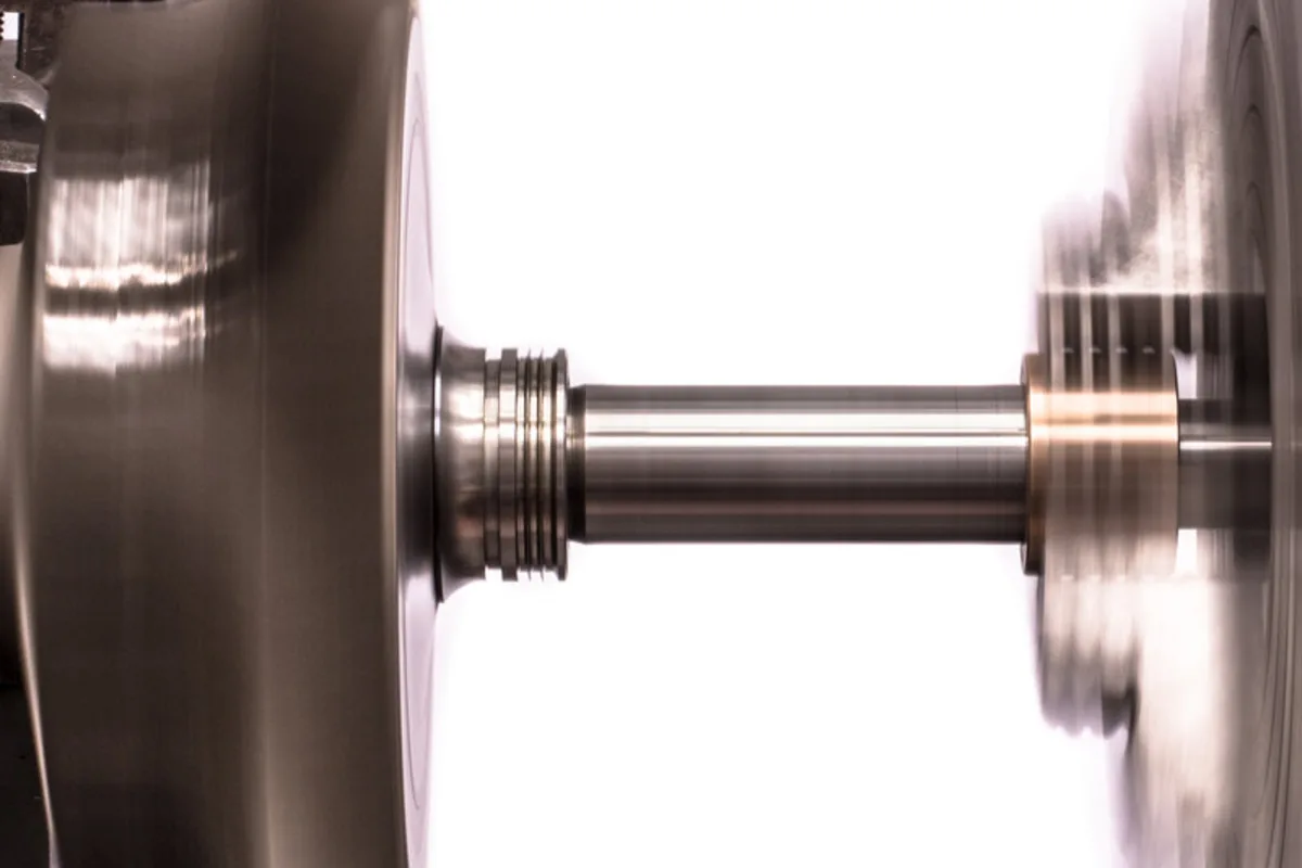 Turbocharger shaft being ground between centres