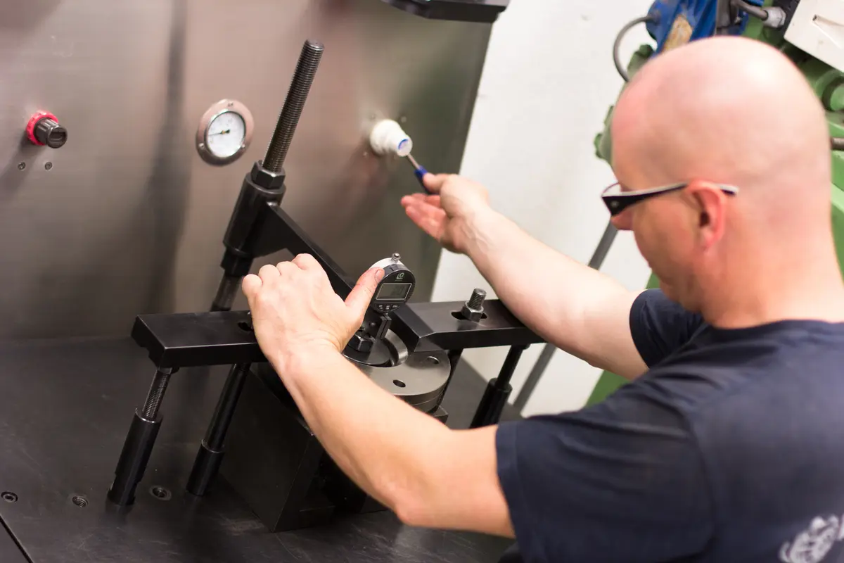Turbocharger bearing component measured with a dial gauge on the test fixture